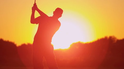 Close up silhouette weekend male golfer enjoying time golf course in summer driving off down fairway sunset shot on RED EPIC, 4K, UHD, Ultra HD resolution