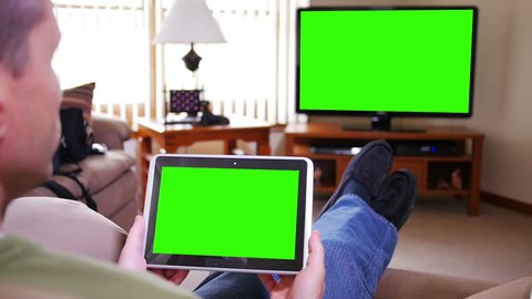 A man watches television while holding a tablet device.  Screens customizable with included optional luma matte and tracking points for advanced tracking.