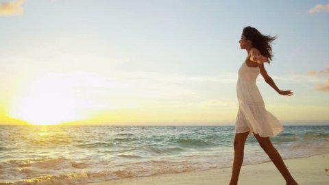 Beautiful Hispanic girl white sundress walking ocean shallows sandy beach sunset shot on RED EPIC, 4K, UHD, Ultra HD resolution