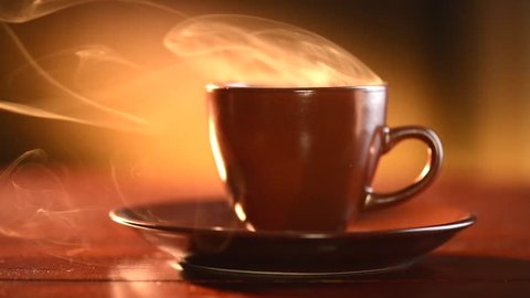 Coffee or Tea. Brown Cup of hot beverage with Steam. Espresso Coffee closeup. HD video Footage