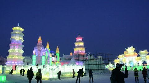 HARBIN, CHINA - DECEMBER 30, 2013: Ice building in Harbin Ice and Snow World. People are visiting. December 30, 2013 in Harbin City, Heilongjiang Province, China.