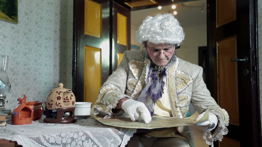 Man looks at an old map and thinks about it