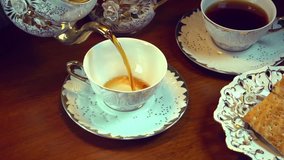 Tea Pouring. Porcelain cup of Healthy Tea closeup. Slow motion video footage 240fps
