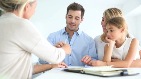 Family signing real-estate contract