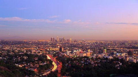 Los Angeles city timelapse. Transition from sunset to night. View from Hollywood Hills on freeway 101 and downtown LA. 4K