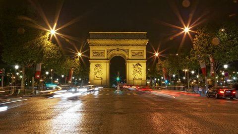 Paris, France - CIRCA 2013: Arch of Triumph at night, Traffic time lapse 4K UHD motion blur