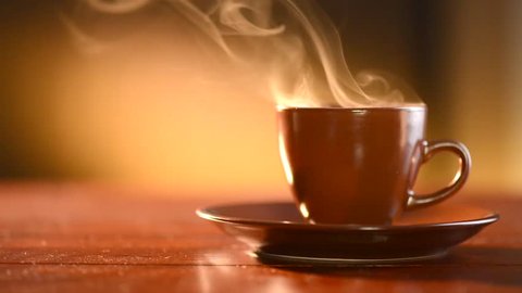 Coffee or Tea. Brown Cup of hot beverage with Steam. Espresso Coffee closeup. HD video Footage
