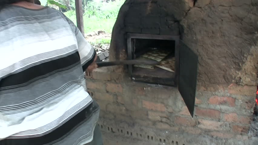 Bread is removed from a brick furnace stove