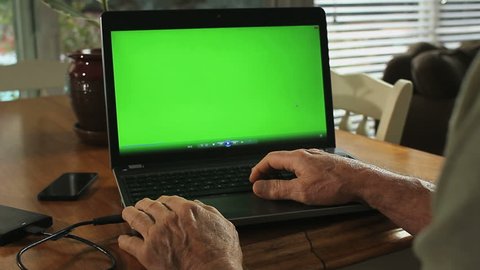 LAPTOP GREEN-SCREEN DOLLY IN WITH HANDS