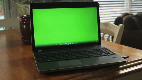 DOLLY IN ON LAPTOP GREEN-SCREEN