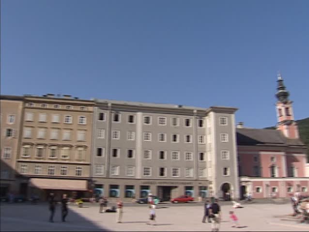 SALZBURG, AUSTRIA - Residenzplatz in the historic city center + pan city square with baroque fountain. The Historic Center of the City of Salzburg UNESCO World Heritage Site.