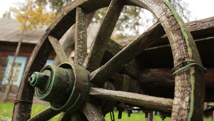 A wheel of an old  wooden cart.