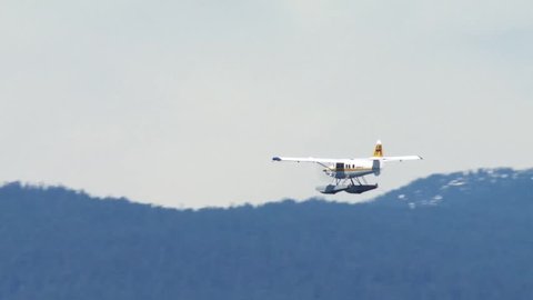 Sea plane flying over mountains in Vancouver, British Columbia.