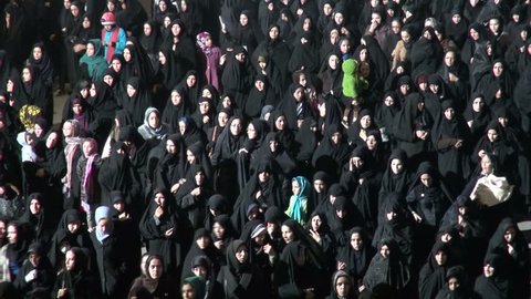 ZANJAN, IRAN - 15 NOVEMBER 2013: Veiled women in traditional black chadors are walking through the streets of Zanjan, to take part in a ceremony to commemorate the Battle of Karbala