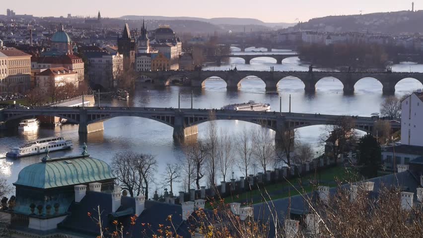 Sunset on Vltava river in Prague with boats.