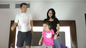 Family Jumping On Bed Together 