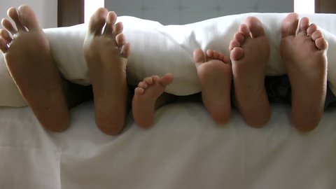 family feet under the sheet 