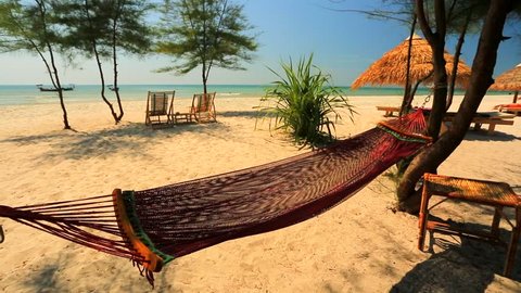 Beautiful hammock on the tropical beach by the sea.