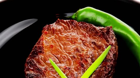 meat food : roast beef fillet mignon served on black plate with chili pepper 1920x1080 intro motion slow hidef hd