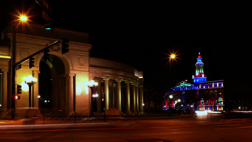 Busy traffic in Denver, Colorado, with the City and County Building, and Civic Center Park architecture. HD 1080p time lapse.