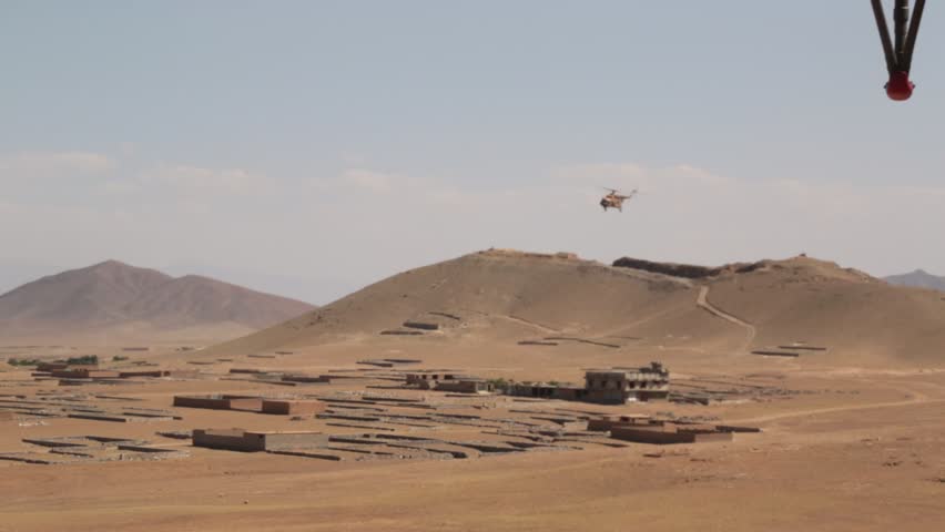 Military Helicopter in Flight Over Desert of  Rural Afghanistan