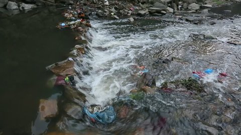 Environmental problems. Plastic Contamination into Nature. Garbage and bottles floating on water. Environmental pollution in the Himalayas. Garbage in the water of river Bagmati. (HD)