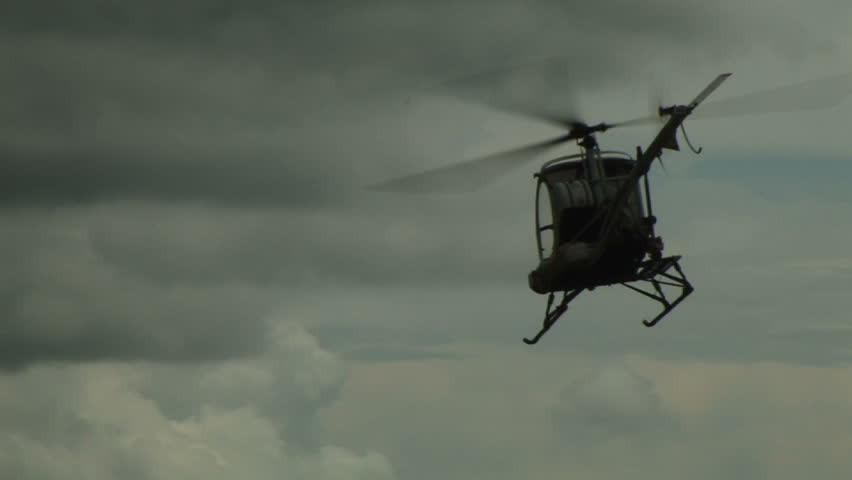 Helicopter flies towards mountains