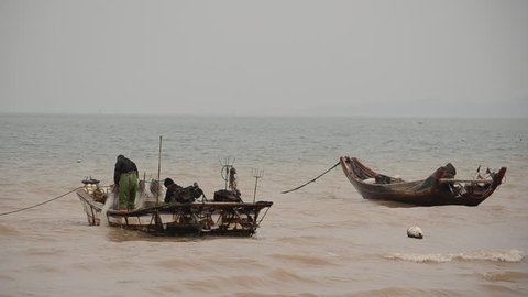 Fisherman boats anchoring on rough sea