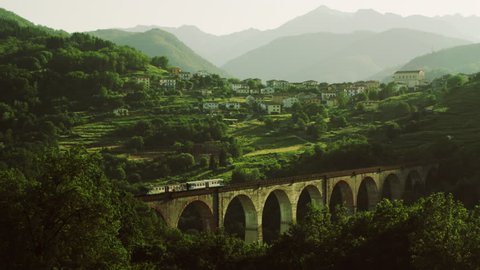 Train going through the Railway Bridge at beautiful Mountain Landscape.Shot on RED Digital Cinema Camera in 4K,so you can easily crop, rotate and zoom, without losing quality! : vidéo de stock