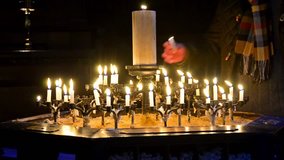 Prayer is igniting candle - Stock Video.  Inside of St. Paul Cathedral with candlelight, London, England