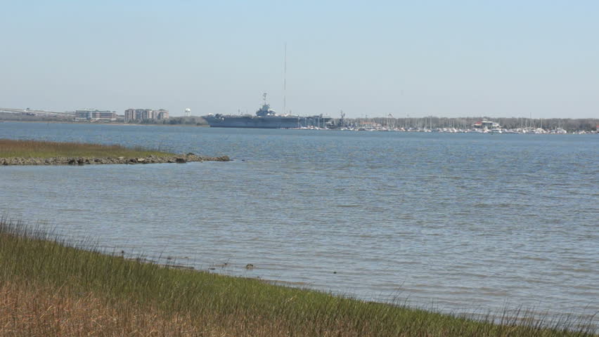 View across the bay near historic Charleston South Carolina with aircraft carrier museum on distant shore