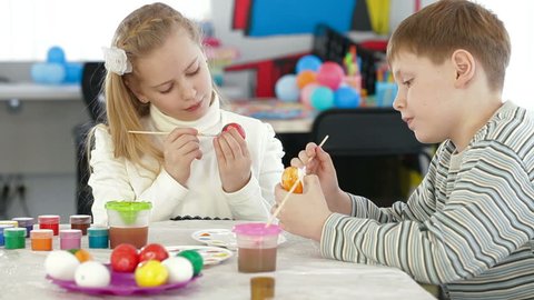 Kids painting easter eggs