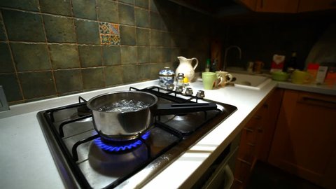 looped Boiling water in the can on natural blue gas, kitchen. Wide Shot (HD, high definition 1080p, seamless loop)
