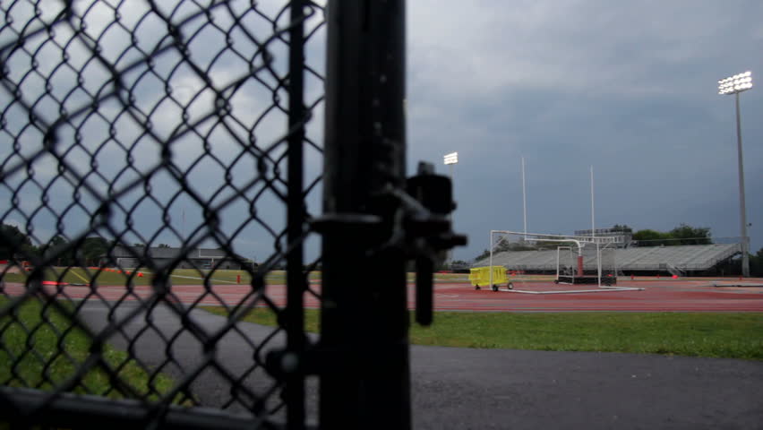 Dolly of a high school football stadium as a storm approaches.