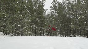 Slow-motion of energetic young people running in the winter woods