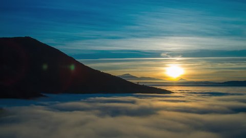 4K sunset timelapse of mountain heights with dense layer of fog