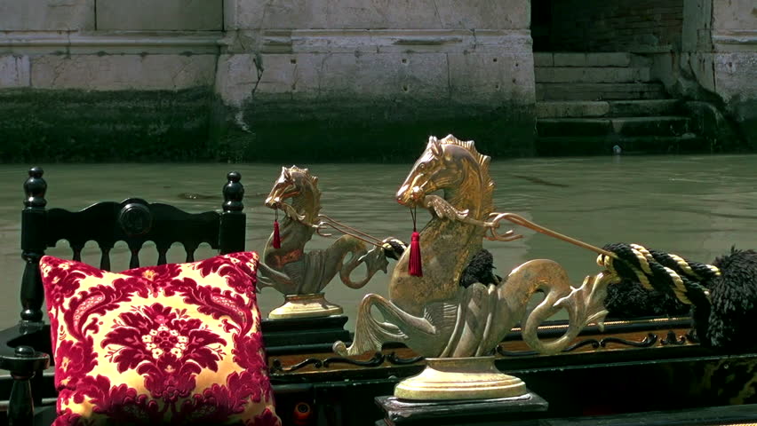 Golden detail of typical venetian gondola riding on water in Venice, Italy