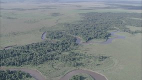Savanna River Migration Africa. A scenic view travels over a savanna in Africa. The scene depicts the landscape of the region. A river bends through the savanna.