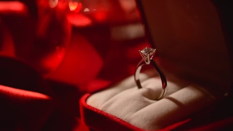Diamond ring. Valentine's Day Gift. Marriage Proposal. Beautiful Ring - white gold with big diamond (one carat) on red silk background. Rotation HD video footage