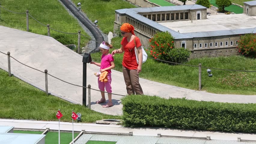 mother and daughter listening comment electronic guide in Istanbul, Turkey
