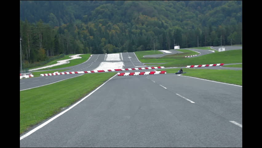 Go-cart drivers driving fast through the turn