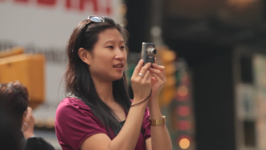 Woman Taking Photos of Busy Times Square, New York 