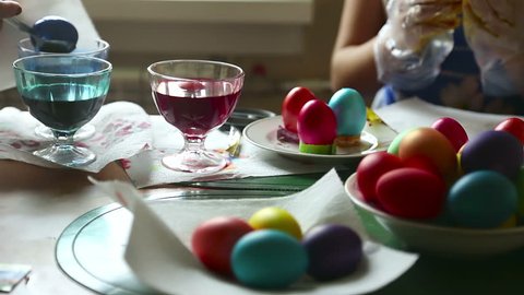 Two women coloring easter eggs.