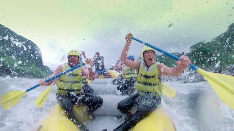 Group Of Senior People Having Fun On Level Five Rafting Adventure In Ecuadorian Andes