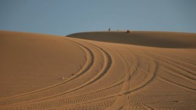 video footage of sandboarding in dunes