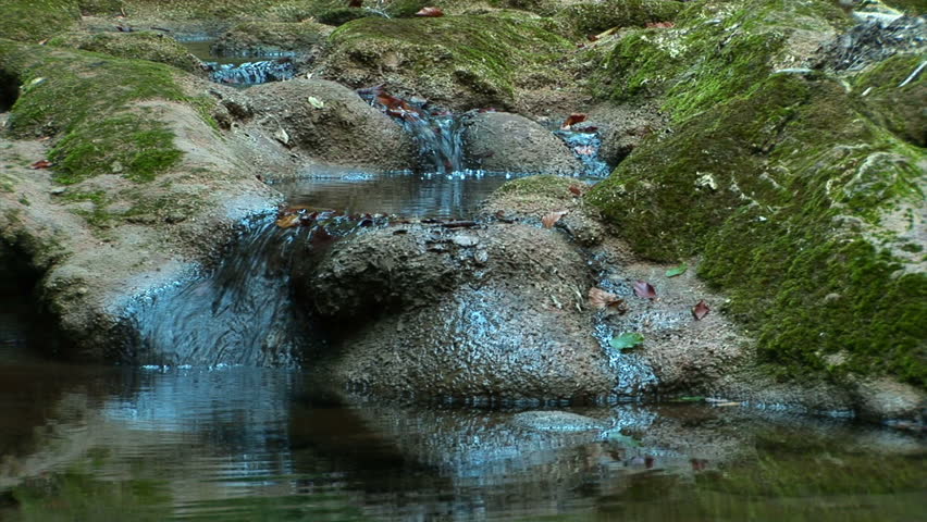 Streams flowing over rocks covered with moss.
