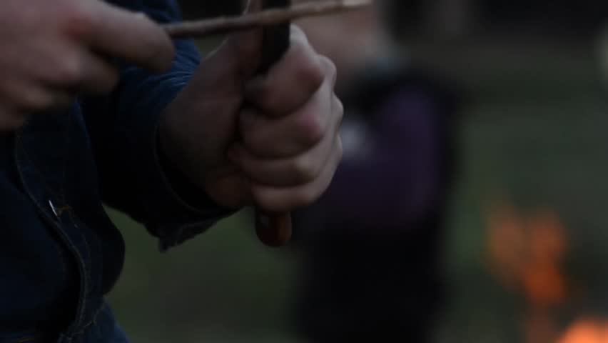 Boy whittles a stick