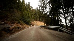 POV Video footage of driving on a countryroad in forest with mountains in south tyrol, Italy