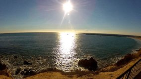 Shot of the sun shining on the ocean. This clip features the shimmering and glistening sun on the waters of the Pacific Ocean at Corona Del Mar Beach in Newport Beach, California.