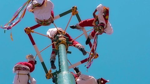 TOTONOCAPAN, MEXICO, 10 JANUARY 2014: Men called Voladores de Papantla, making their dance on the air for fertility of the earth during a town festivity 